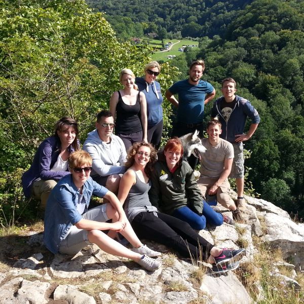 A guided walk group sat on Seven Sisters Rocks