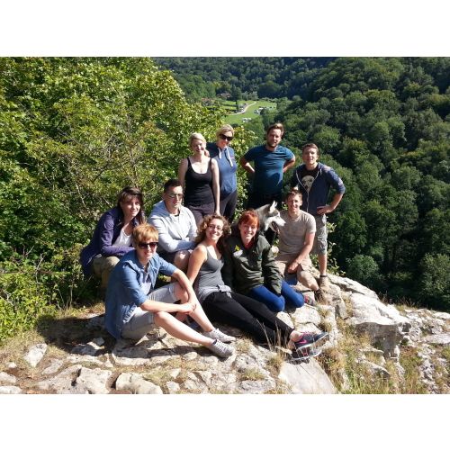 A guided walk group sat on Seven Sisters Rocks